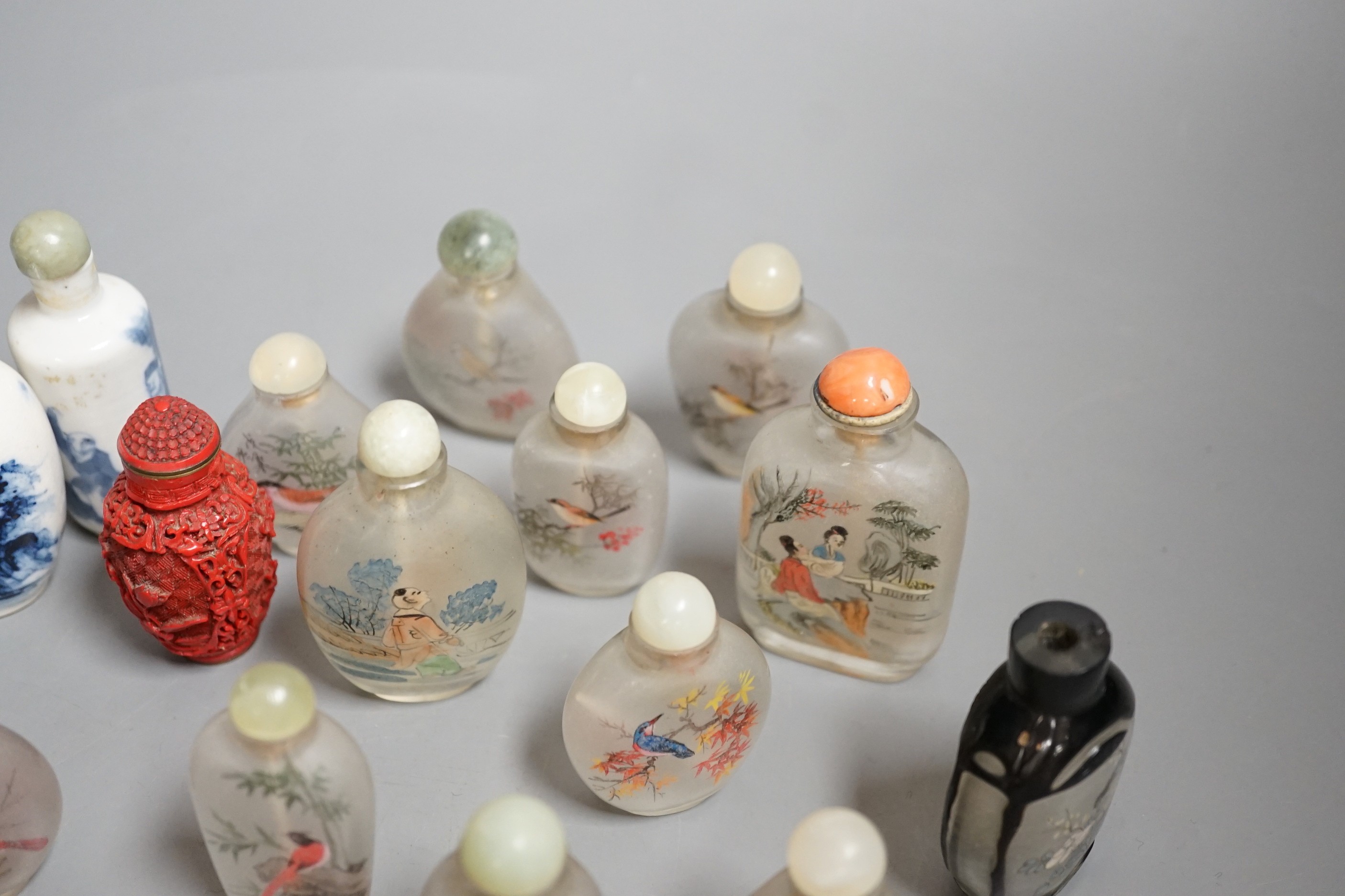 A collection of 20th century Chinese export reverse painted snuff bottles with associated blue and white porcelain examples, some 19th century